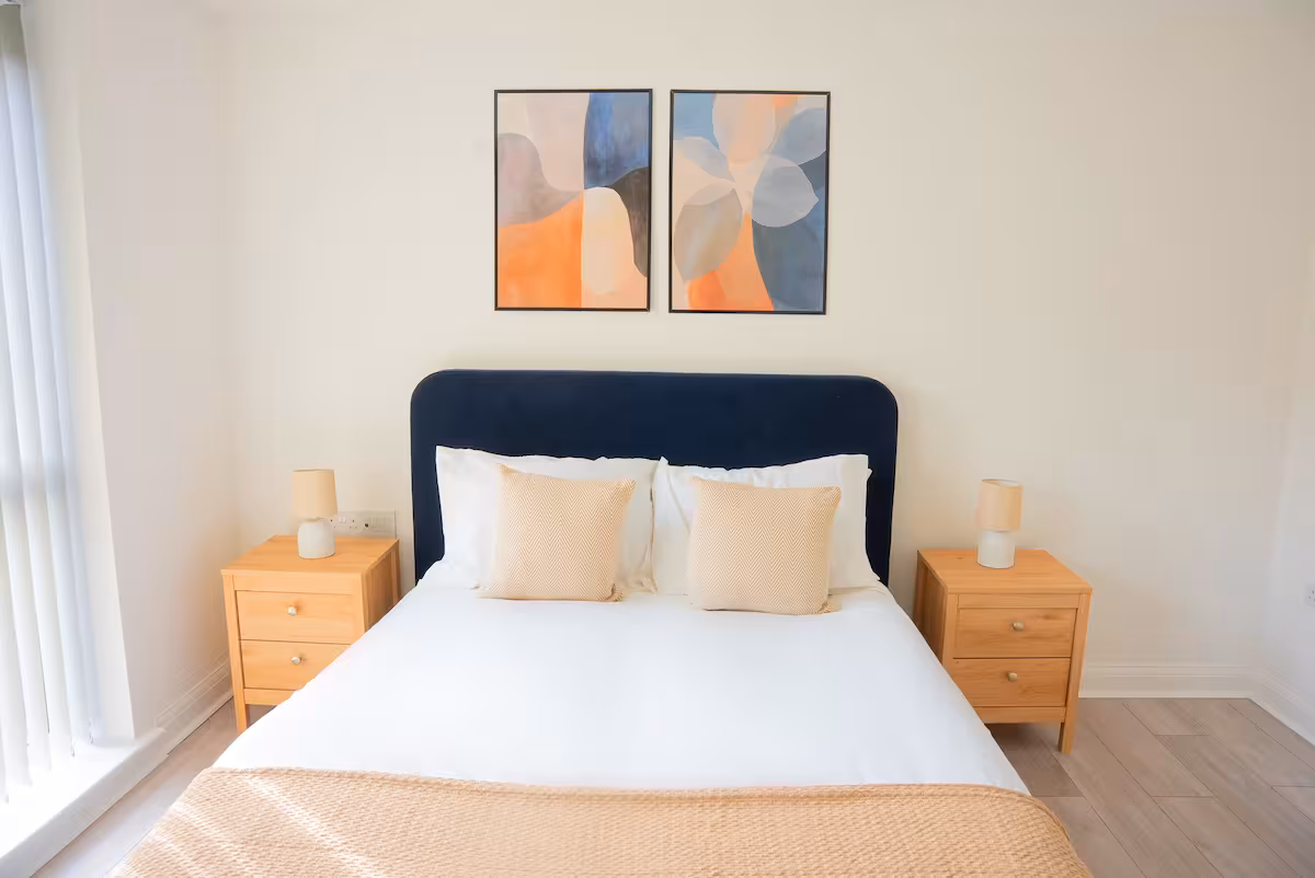 Propora Stays Birmingham — bedroom with navy headboard